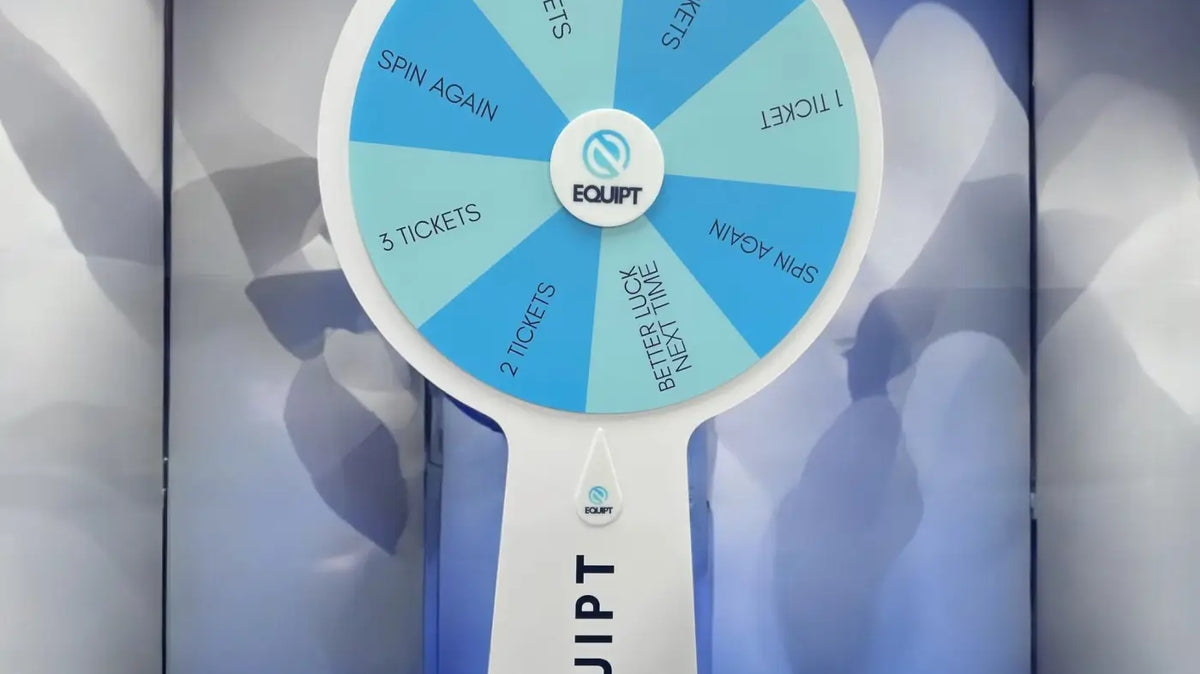 Blue and turquoise EQUIPT branded spinning prize wheel at an exhibition