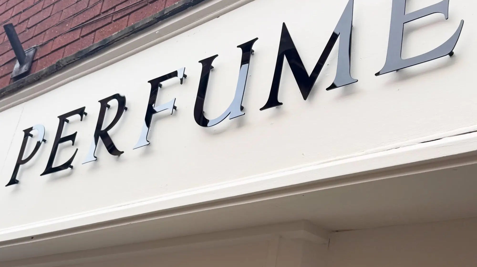 Perfume laboratory: monochrome shop signage designed to define the brand