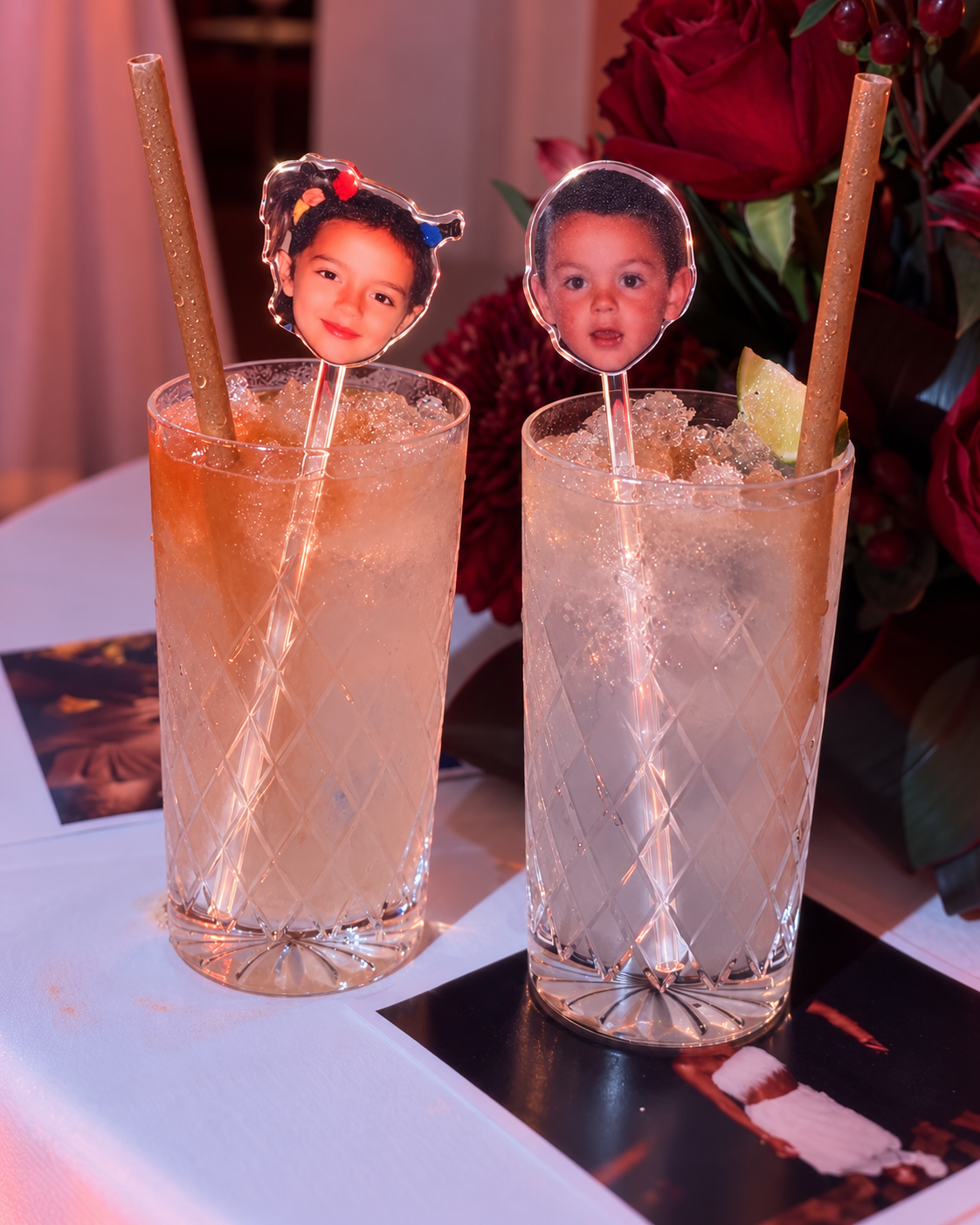 Clear personalised childhood photo drinks stirrers displayed in two cocktail glasses