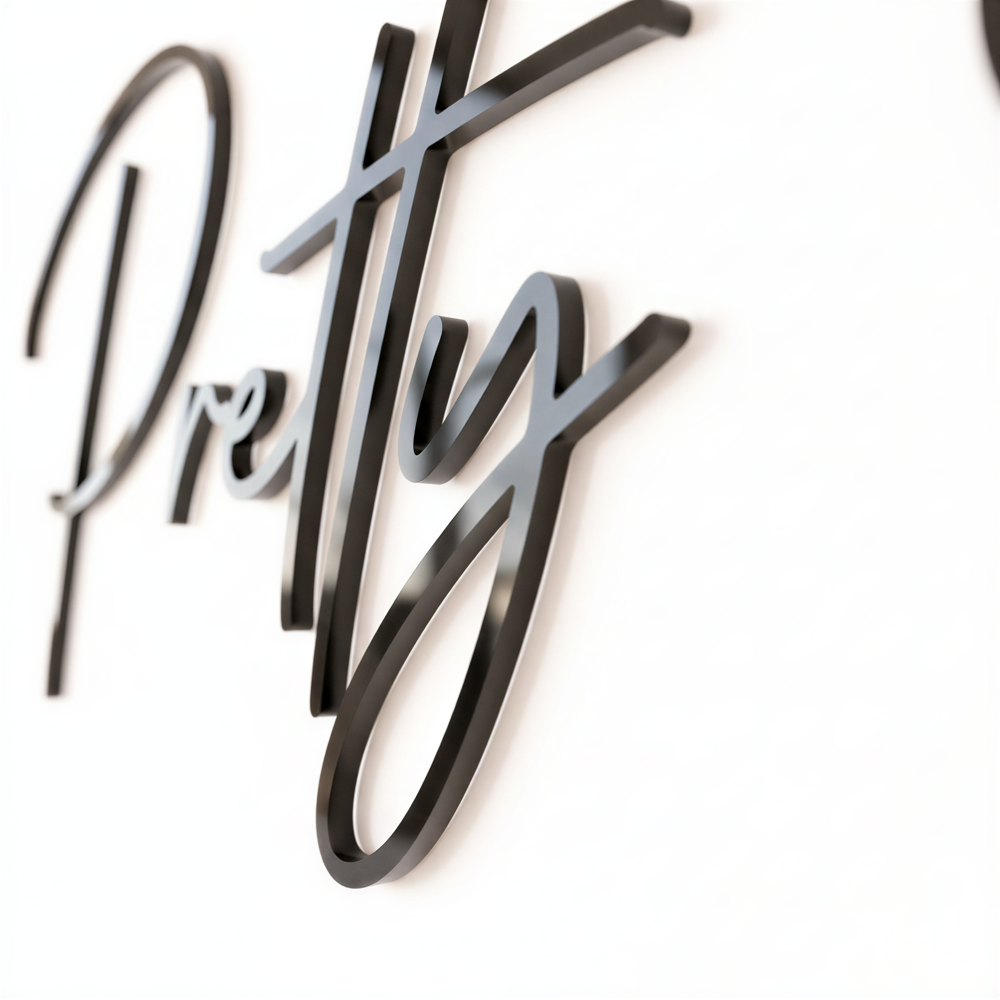 a close-up view of a black cursive text that reads "Pretty".