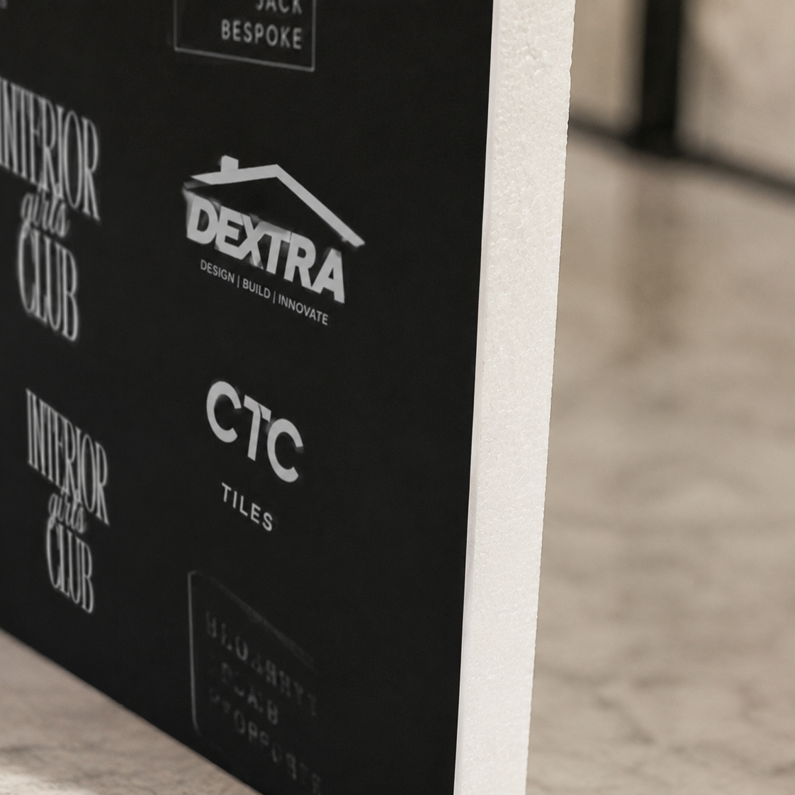 a collection of logos and text on a black background, including the words "INTERIOR GIRLS CLUB", "DEXTRA", "CTC", "TILES", and "HADDON".