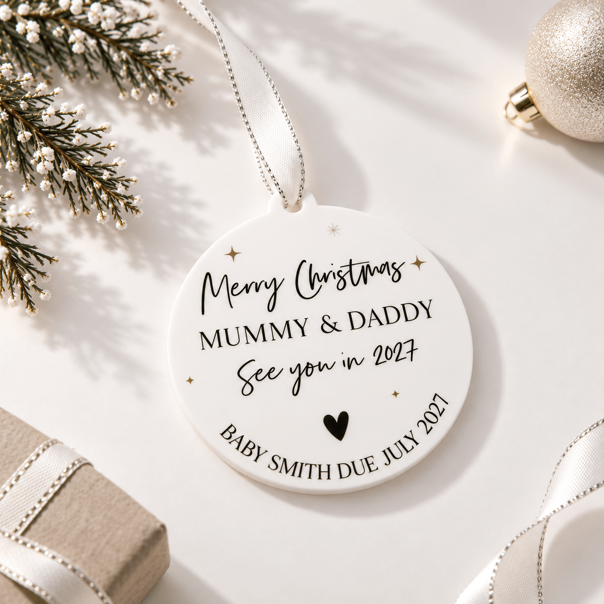 Personalised baby's first Christmas bauble featuring a custom name design