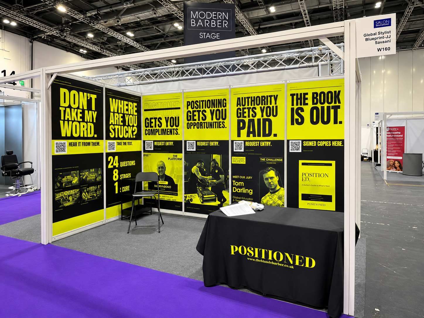 Yellow and black shell scheme exhibition graphics with bold headlines and QR codes