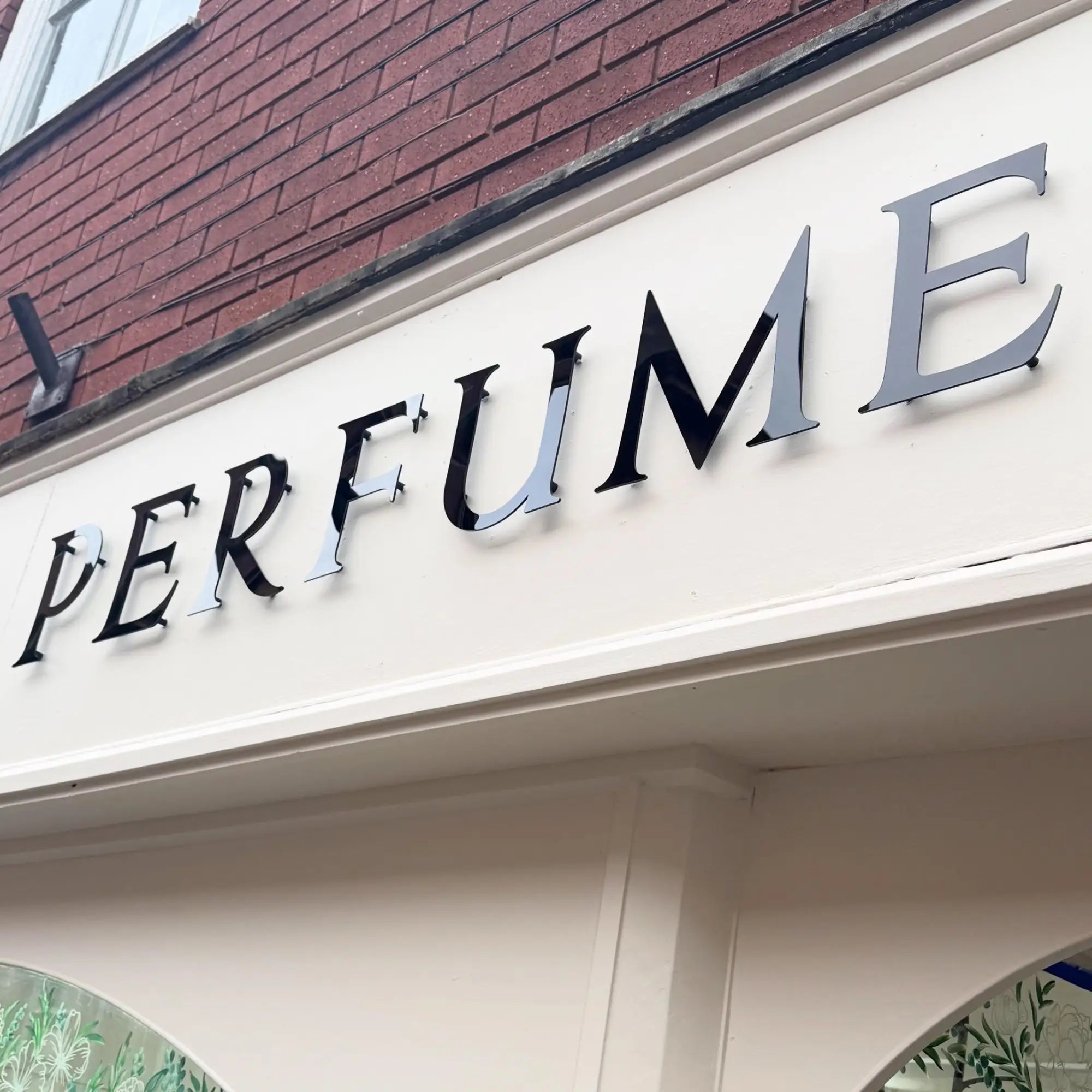 Perfume laboratory: monochrome shop signage designed to define the brand