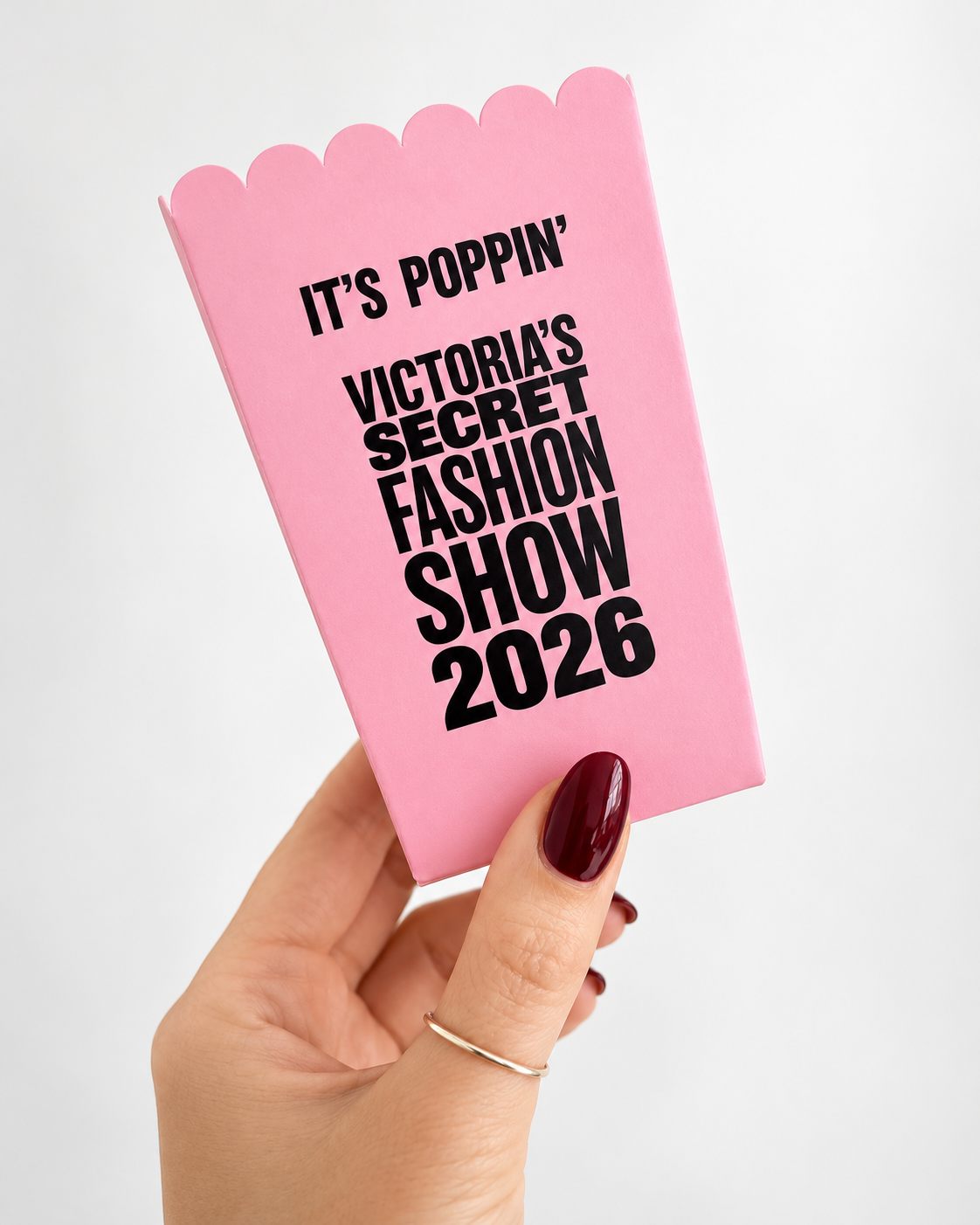 Pink popcorn box produced by Printlux with black Victoria’s Secret Fashion Show 2026 branding and a scalloped opening