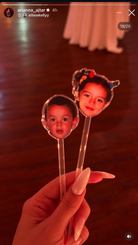 Two clear drinks stirrers with personalised childhood photo face designs