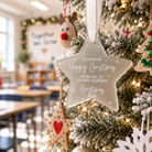 A Christmas tree decorated with ornaments, including a star-shaped ornament with a personalized message, and other festive decorations.