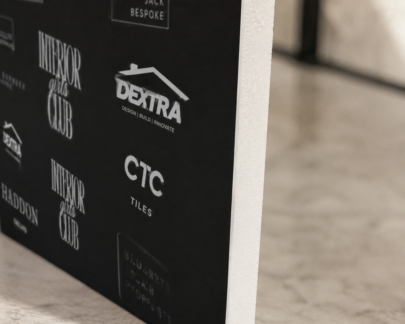 a collection of logos and text on a black background, including the words "INTERIOR GIRLS CLUB", "DEXTRA", "CTC", "TILES", and "HADDON".