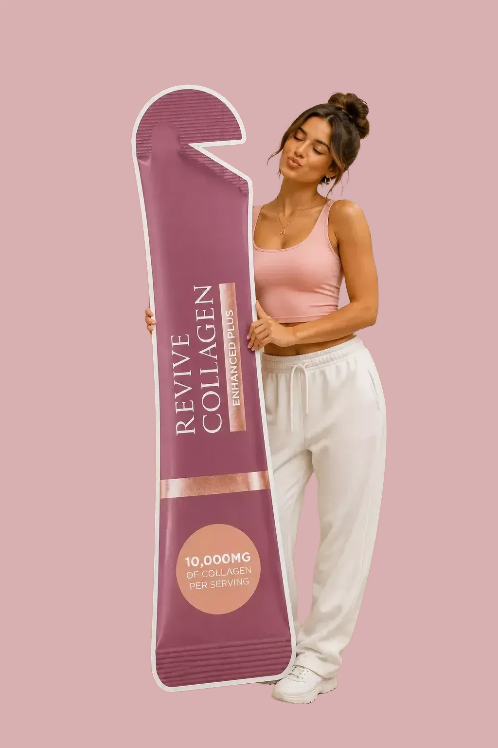 A woman in a pink tank top and white pants is holding a large collagen supplement package, which is pink and white in color.