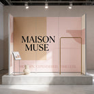 a display stand with a large text banner that reads "MAISON MUSE" and a smaller text banner below that says "MODERN. CONSIDERED. TIMELESS."