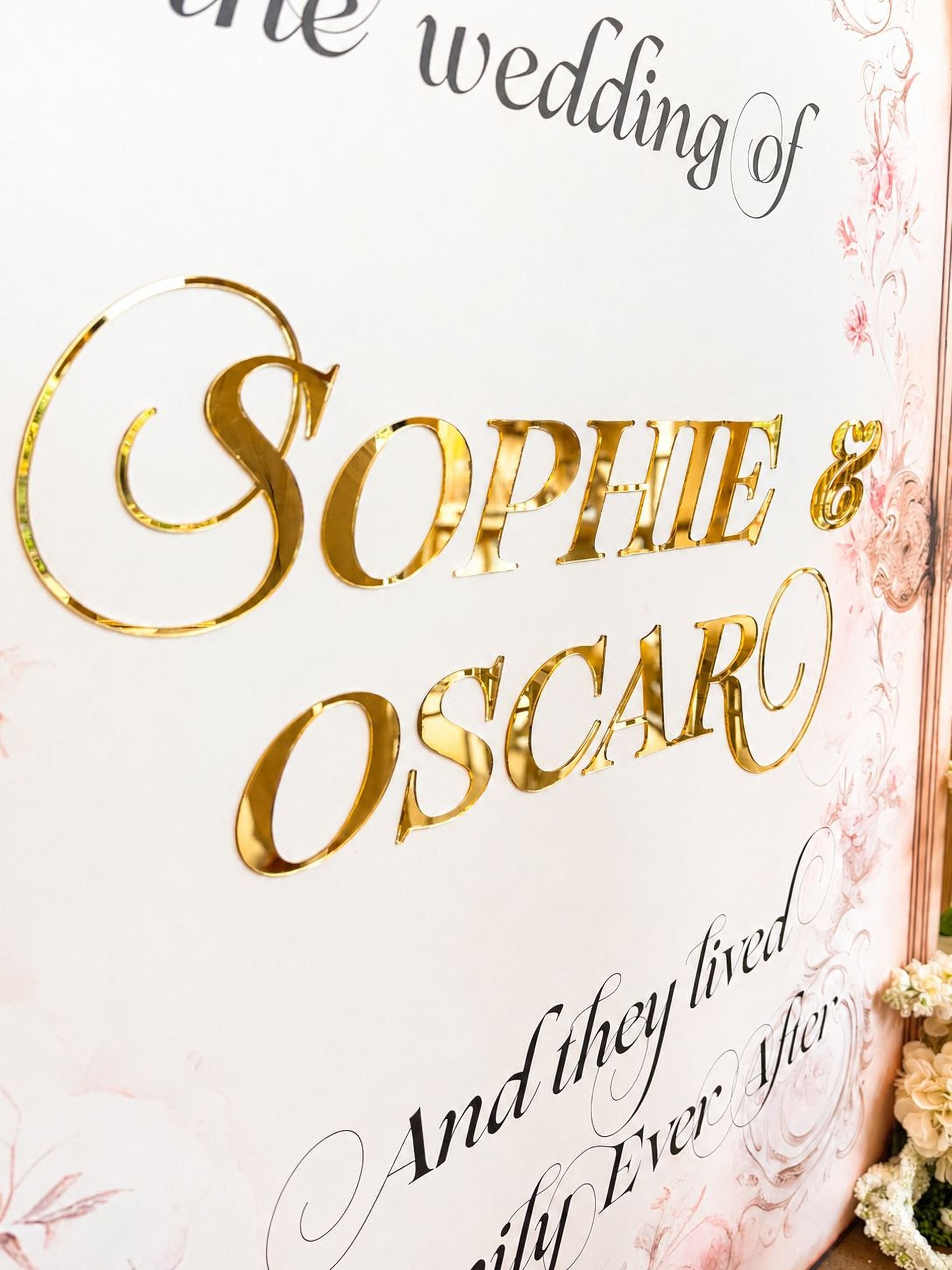 a close-up of a sign with the names "Sophie & Oscar" written in a decorative font.