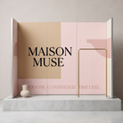 a minimalist display with a large text logo on a pink background, a white vase, and a gold railing.
