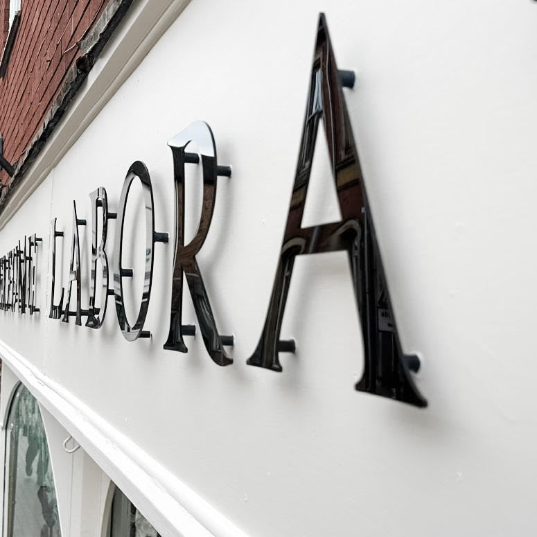 Perfume laboratory: monochrome shop signage designed to define the brand